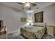 Bright bedroom with a decorative ceiling fan, two framed palm tree art pieces, and a leafy bedspread at 601 Hillside Dr. N # 3704, North Myrtle Beach, SC 29582
