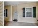 Condo exterior featuring a well-lit entrance, unit number 3704, and neutral siding with contrasting shutters, creating a welcoming appeal at 601 Hillside Dr. N # 3704, North Myrtle Beach, SC 29582