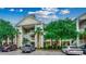Attractive condo exterior with stacked balconies, mature trees, and ample parking at 601 Hillside Dr. N # 3704, North Myrtle Beach, SC 29582