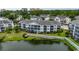 Exterior showcases the condominium building surrounded by lush greenery, a pond, and well-maintained grounds at 601 Hillside Dr. N # 3704, North Myrtle Beach, SC 29582