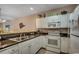 Well-lit kitchen featuring white cabinets, granite countertops, and stainless steel appliances at 601 Hillside Dr. N # 3704, North Myrtle Beach, SC 29582