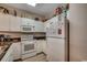 Bright kitchen with white appliances, ample cabinet space, and dark countertops at 601 Hillside Dr. N # 3704, North Myrtle Beach, SC 29582