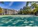 Well-maintained tennis court surrounded by tall trees, offering a private and scenic recreational space at 601 Hillside Dr. N # 3704, North Myrtle Beach, SC 29582