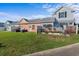 Exterior view of peach home with a beautiful backyard with adjacent homes at 603 Wave Rider Ln. # 603, North Myrtle Beach, SC 29582