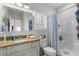 Bathroom vanity features granite countertop, white cabinets, and a walk-in shower with blue shower curtain at 603 Wave Rider Ln. # 603, North Myrtle Beach, SC 29582