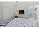 Bedroom with white walls, a patterned bedspread, shuttered windows, and a wall-mounted television at 603 Wave Rider Ln. # 603, North Myrtle Beach, SC 29582