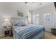 Bright bedroom with a vaulted ceiling, blue-themed decor, and a door leading to the outside at 603 Wave Rider Ln. # 603, North Myrtle Beach, SC 29582