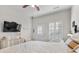 Bedroom with a vaulted ceiling, shutters, door to the exterior, wall-mounted television, and side table at 603 Wave Rider Ln. # 603, North Myrtle Beach, SC 29582