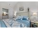 Vaulted bedroom featuring a closet with mirrored doors, a painting, and comfortable bedding at 603 Wave Rider Ln. # 603, North Myrtle Beach, SC 29582