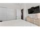 Bright bedroom featuring a comfortable bed, closet, and a dresser with a TV at 603 Wave Rider Ln. # 603, North Myrtle Beach, SC 29582