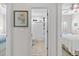 Hallway view leading to a bathroom with a white shower curtain and a bedroom with a bed and ceiling fan at 603 Wave Rider Ln. # 603, North Myrtle Beach, SC 29582