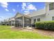 Charming backyard featuring a grill, patio and a screened-in porch on a sunny day at 6203 Catalina Dr. # 212, North Myrtle Beach, SC 29582