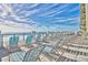 View of a sunny balcony offering ocean views and blue chairs at 6203 Catalina Dr. # 212, North Myrtle Beach, SC 29582