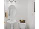 Elegant half bath with a pedestal sink, decorative mirror, and tasteful décor at 6203 Catalina Dr. # 212, North Myrtle Beach, SC 29582