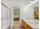 Bright bathroom boasts a double vanity and shower with glass doors at 6203 Catalina Dr. # 212, North Myrtle Beach, SC 29582