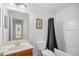 Traditional bathroom featuring a single sink vanity, a mirror, and a tub with a gray curtain at 6203 Catalina Dr. # 212, North Myrtle Beach, SC 29582