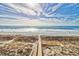Scenic beach access with a wooden walkway leading to the sandy shore and ocean at 6203 Catalina Dr. # 212, North Myrtle Beach, SC 29582