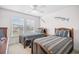 Bedroom featuring two twin beds, a ceiling fan and a window with outside views at 6203 Catalina Dr. # 212, North Myrtle Beach, SC 29582