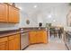 Kitchen featuring wood cabinets, stainless steel appliances, and a view into the living space at 6203 Catalina Dr. # 212, North Myrtle Beach, SC 29582