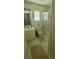 Bathroom showcasing a tiled shower, white sink vanity, toilet, and neutral tile flooring at 700 Two Rivers Ct., Myrtle Beach, SC 29579