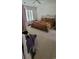 Bedroom featuring a wrought iron bed frame, neutral carpet, plantation shutters and a ceiling fan at 700 Two Rivers Ct., Myrtle Beach, SC 29579