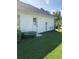 Exterior view of the home showcasing the manicured lawn and a private entrance on a sunny day at 700 Two Rivers Ct., Myrtle Beach, SC 29579