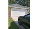 Brick garage with a white garage door, driveway, and car parked in the front at 700 Two Rivers Ct., Myrtle Beach, SC 29579