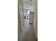 Hallway leading to the bathroom with white cabinets and plush neutral carpeting at 700 Two Rivers Ct., Myrtle Beach, SC 29579