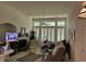 Spacious living room featuring large windows with shutters, fireplace and ceiling fan at 700 Two Rivers Ct., Myrtle Beach, SC 29579