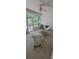 Cozy screened-in patio with comfortable seating, ceiling fan, and views of the backyard at 700 Two Rivers Ct., Myrtle Beach, SC 29579