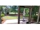 View of serene backyard with mature trees from the screened-in patio at 700 Two Rivers Ct., Myrtle Beach, SC 29579