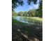 Scenic view of the pond with a fountain feature and lush green surroundings on a sunny day at 700 Two Rivers Ct., Myrtle Beach, SC 29579
