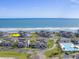 Aerial view of condos near the beach with a community pool and well-maintained lawns at 701 Norris Dr., Pawleys Island, SC 29585