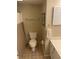 Neutral bathroom with a toilet, sink, towel bar, and tiled floor at 701 Norris Dr., Pawleys Island, SC 29585