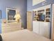Bright bedroom featuring a white dresser and TV, complete with built-in shelves, offering both style and convenience at 701 Norris Dr., Pawleys Island, SC 29585