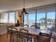 Bright dining area features a wood table, wicker chairs, and ocean views through sliding glass doors to the outside deck at 701 Norris Dr., Pawleys Island, SC 29585