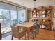 Dining room with hardwood floors, hutch, farm table, and balcony access at 701 Norris Dr., Pawleys Island, SC 29585