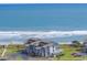 Coastal condo complex overlooking a stunning beachfront with white waves and lush landscape at 701 Norris Dr., Pawleys Island, SC 29585