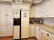 Bright kitchen featuring white cabinets, tile countertops, and stainless steel appliances at 701 Norris Dr., Pawleys Island, SC 29585
