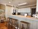 Bright kitchen features white cabinets, counter seating and tile countertops at 701 Norris Dr., Pawleys Island, SC 29585