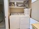 Laundry room including a white washer and dryer set and shelf storage at 701 Norris Dr., Pawleys Island, SC 29585