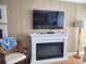 Living room with fireplace, television, lamp, chair, and wood flooring at 701 Norris Dr., Pawleys Island, SC 29585