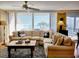 Cozy living room with large windows offering ocean views and a comfortable sectional sofa at 701 Norris Dr., Pawleys Island, SC 29585