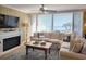 Comfortable living room with fireplace and large windows offering beach views with a sectional sofa at 701 Norris Dr., Pawleys Island, SC 29585