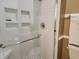 Modern shower with glass door and convenient built-in shelving at 701 Norris Dr., Pawleys Island, SC 29585