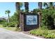 Community sign at entrance with lush greenery, indicating a private neighborhood at 701 Norris Dr., Pawleys Island, SC 29585