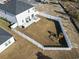 Aerial view of a fenced backyard with a patio, playground set, and a spacious lawn at 7094 Watercress St, Myrtle Beach, SC 29579
