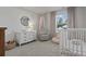 Charming Bedroom with a crib, dresser, and comfortable chair, bathed in soft natural light at 7094 Watercress St, Myrtle Beach, SC 29579