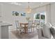 Bright dining area featuring stylish light fixture, natural light, and a seamless transition to outdoor living at 7094 Watercress St, Myrtle Beach, SC 29579