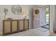 Inviting entryway showcasing a decorative console table with a round mirror and an open doorway at 7094 Watercress St, Myrtle Beach, SC 29579